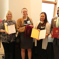 Members of the Hijab Initiative holding award certificates with Dean Meredith McQuaid
