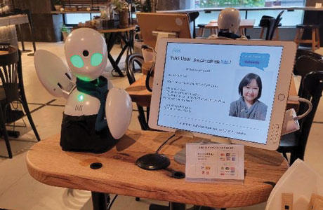 Robot next to a computer monitor