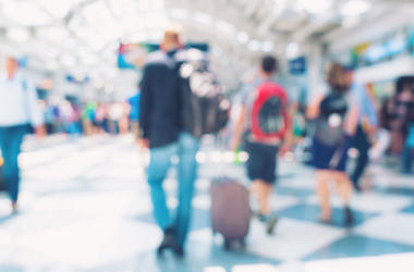 Diffused photo of people walking through an airport