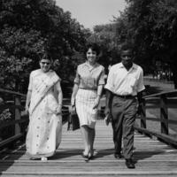 1961: Three international students walk across a small bridge