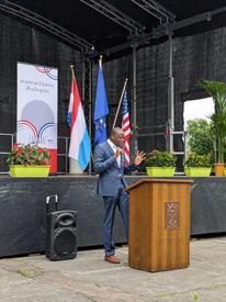 Harvey Charles giving a plenary speech at a podium