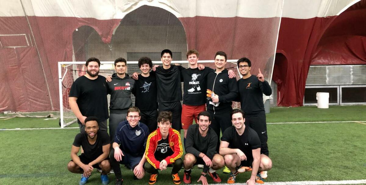 Rigoberto and teammates pose on the soccer field