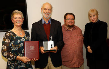 Dennis Falk, pictured with Dean Meredith McQuaid, nominator David Bear, and Provost Karen Hanson