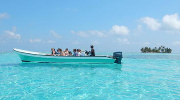 several people on a small boat in the water