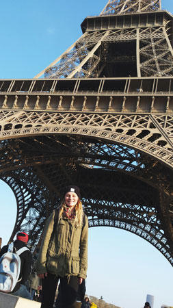 a person standing in front of the eiffel tower