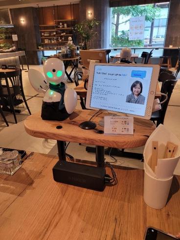 An IPad in a cafe with a robot 