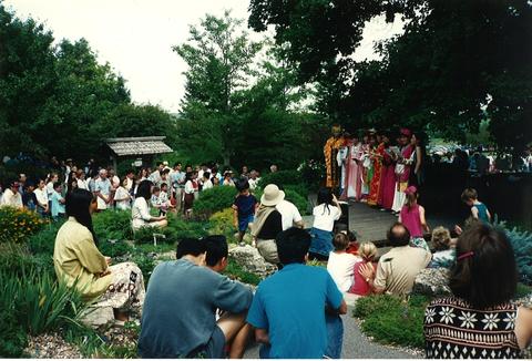 People gathered outside while signers perform in traditional dress